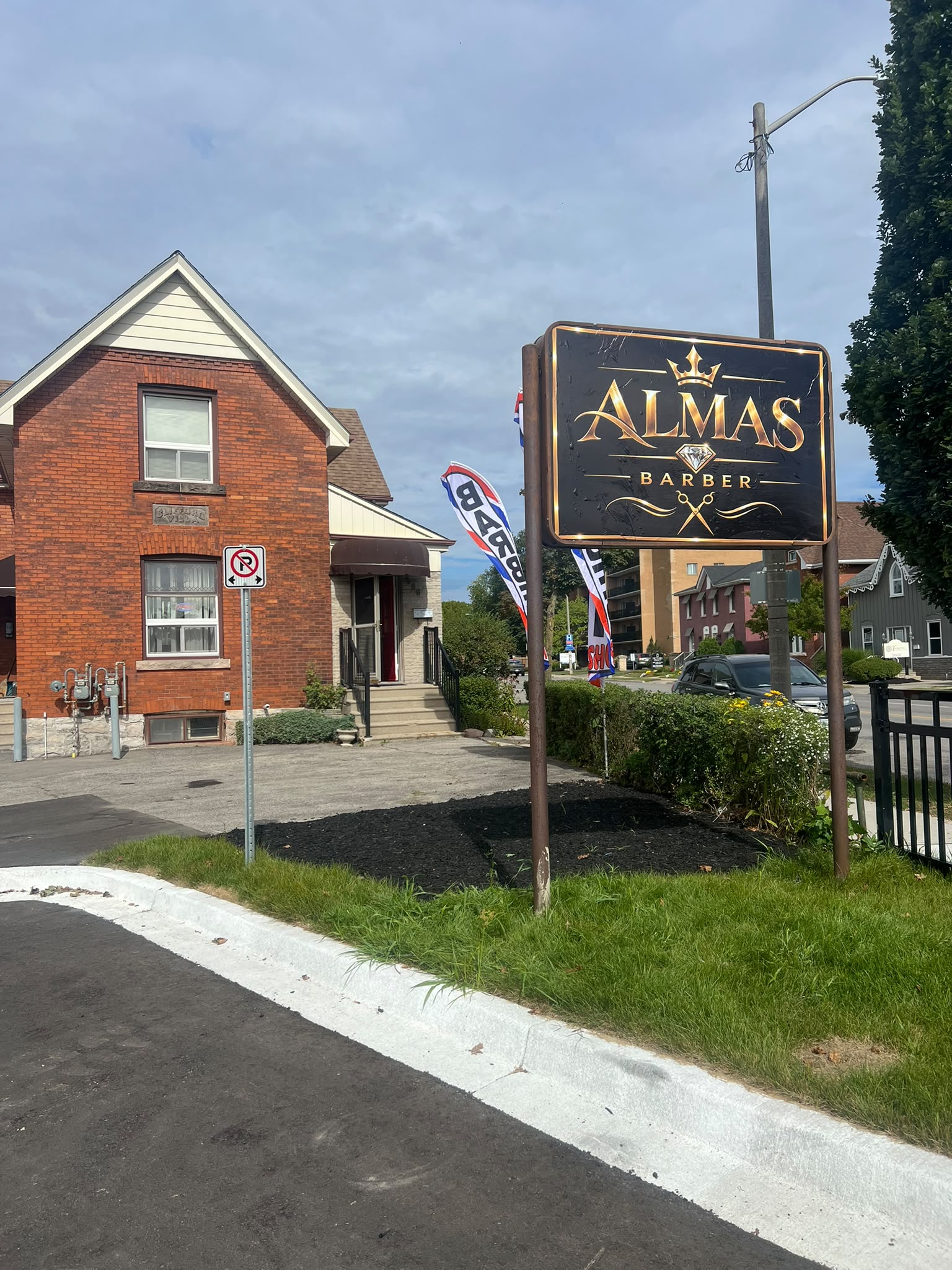 ALMAS BARBER storefront and sign on Brant Ave